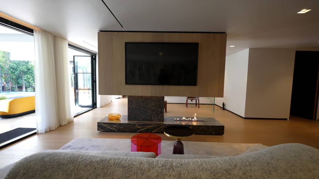 A guest room with a unique TV wall
